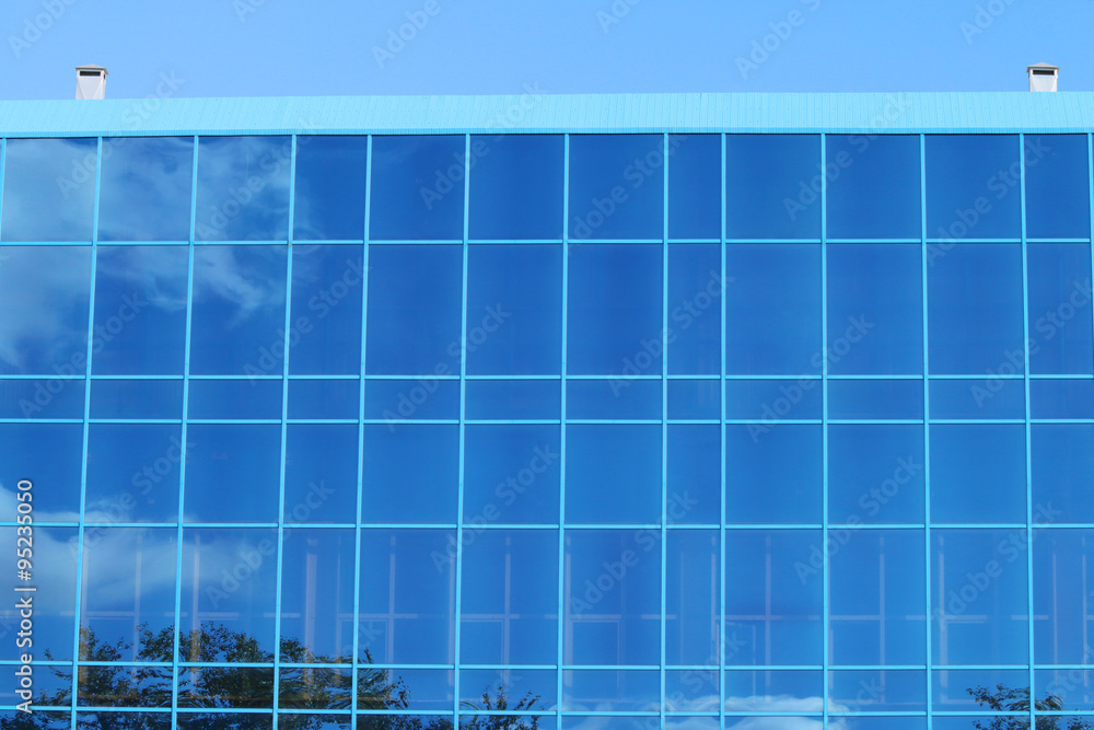 Part of modern building with blue windows with reflection 