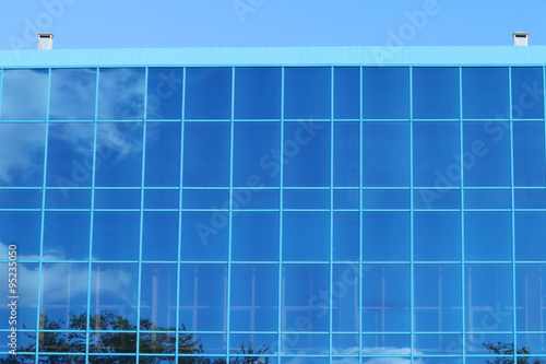 Part of modern building with blue windows with reflection 