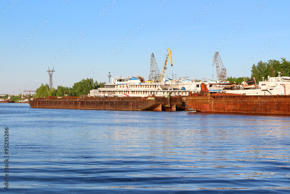 Fototapeta premium Old rusty freight ships, cranes for loading and passenger liner