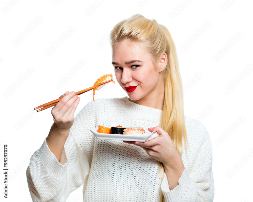Young woman holding sushi with a chopsticks, isolated on white Young woman holding sushi with a chopsticks, isolated on white