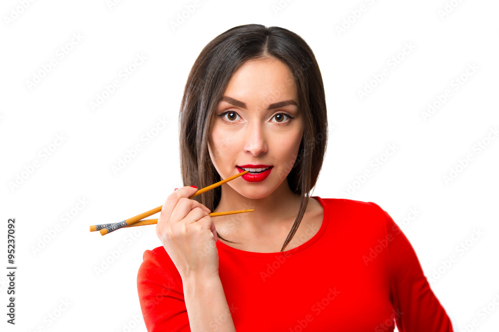 Young woman holding sushi with a chopsticks, isolated on white