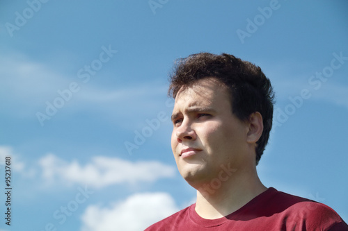 Close up view of young handsome sad man 