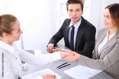 Business people shaking hands, finishing up a meeting. Copy space at the left corner