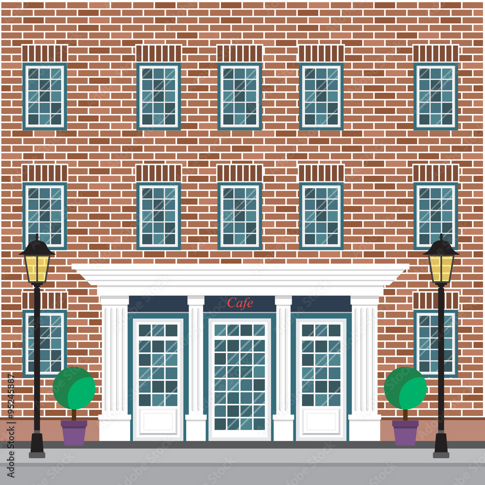 Obraz premium Facade of the building with cafe on the ground floor. The brick facade of the building with detailed windows.