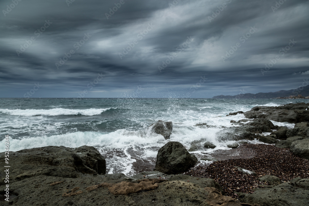 Rough seas and dark clouds over Sardinian coastline