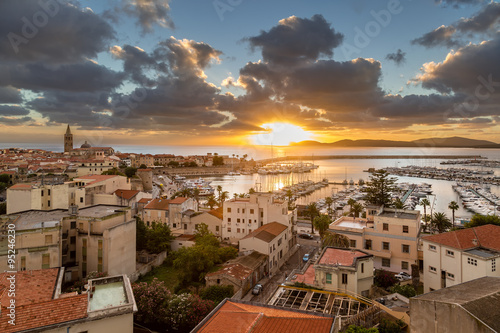 Sunset over city of Alghero on west coast of Sardinia photo