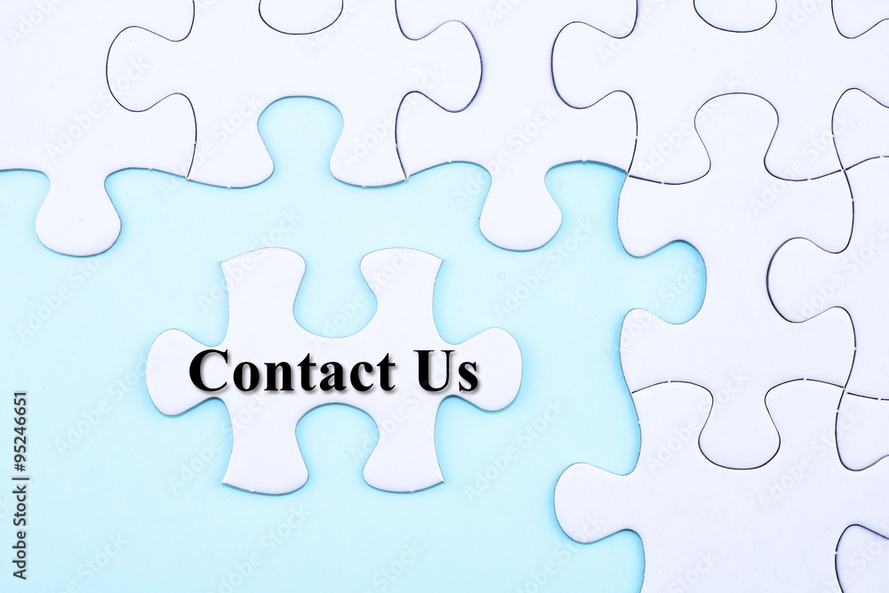 Fototapeta premium Puzzle written word Contact Us on blue background