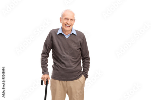 Fotografi Senior man with a cane smiling and posing
