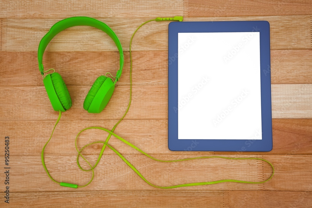 View of a green headphone with a blue tablet View of a green headphone with a blue tablet