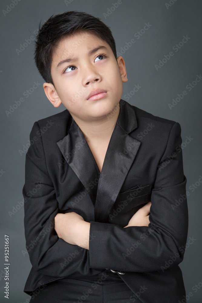 Little asian boy in black suit upset, depression face Little asian boy in black suit upset, depression face