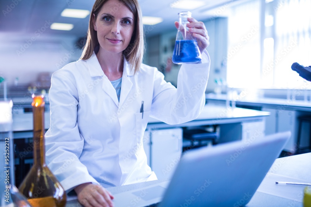 Scientist working with a laptop in laboratory Scientist working with a laptop in laboratory