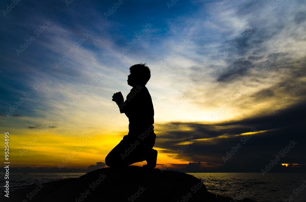 praying man on beautiful sky background