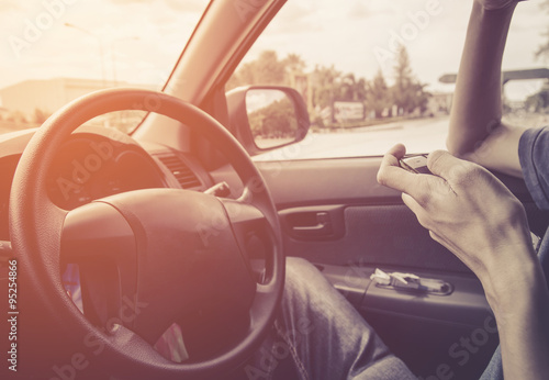 transportation concept , man play cellphone on drive in car