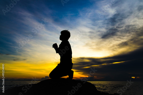 praying man on beautiful sky background