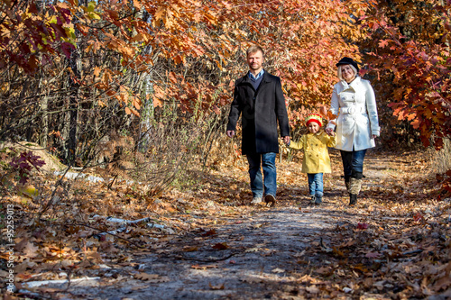 Two Generation Family Walking in Autumnal Forest Front View