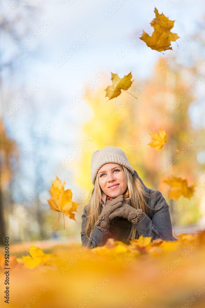 Young woman lying on leaves Young woman lying on leaves