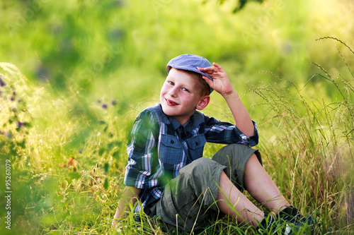 7-years boy in retro cap outdoors portrait .