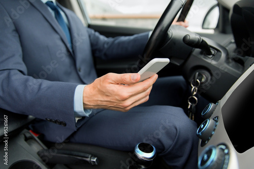 close up of man with smartphone driving car © Syda Productions