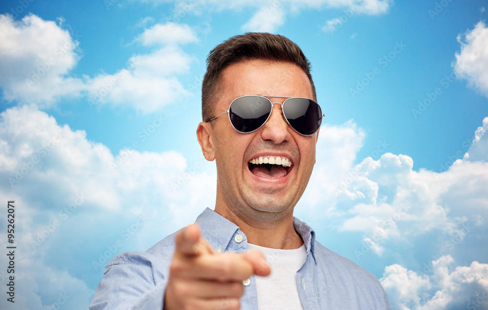 laughing man in sunglasses pointing finger on you laughing man in sunglasses pointing finger on you