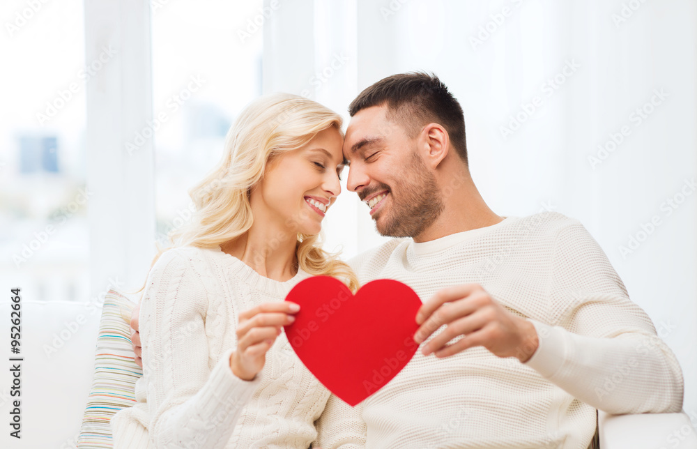happy couple with red heart hugging at home happy couple with red heart hugging at home
