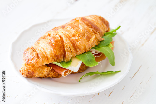 Sandwich croissant with ham brie arugula