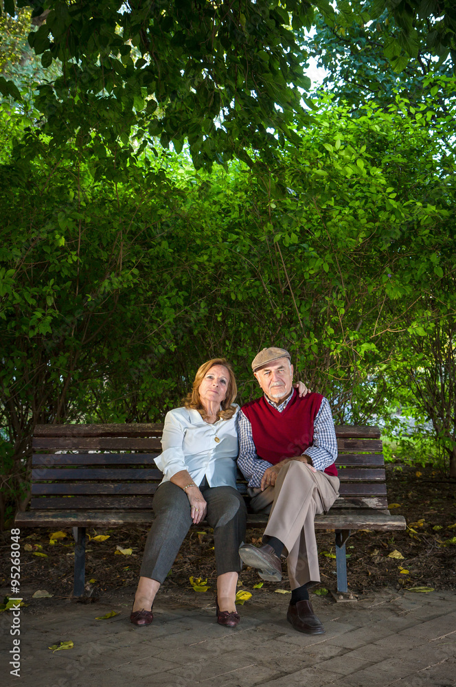senior couple sitting on a bench senior couple sitting on a bench