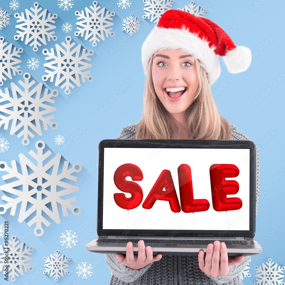 Composite image of festive blonde holding a laptop Composite image of festive blonde holding a laptop