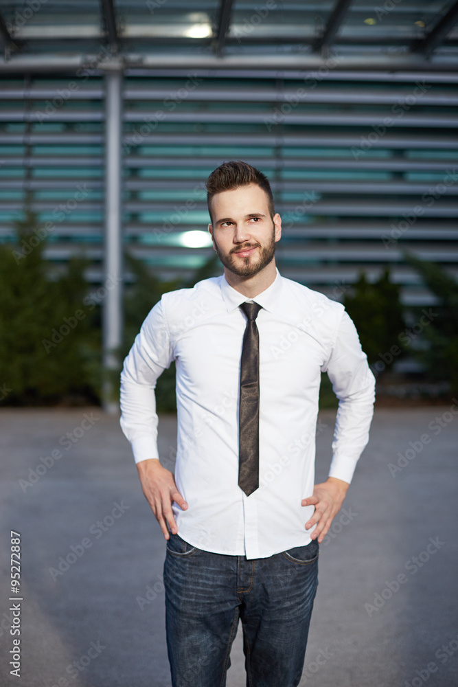 Friendly and smiling handsome businessman looking confidently at