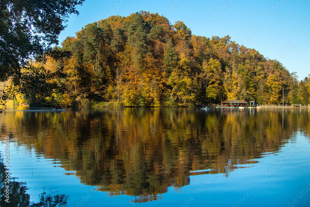     Boat floating on Trakoscan lake in Zagorje, Croatia, season, autumn, Reflection of trees on water 