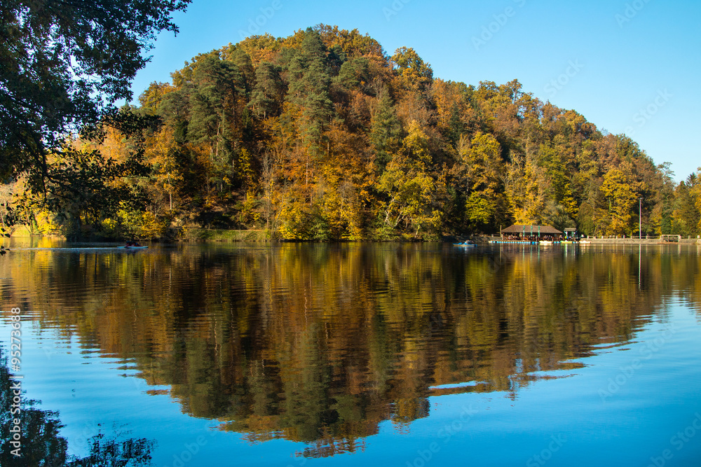 Boat floating on Trakoscan lake in Zagorje, Croatia, season, autumn, Reflection of trees on water Boat floating on Trakoscan lake in Zagorje, Croatia, season, autumn, Reflection of trees on water