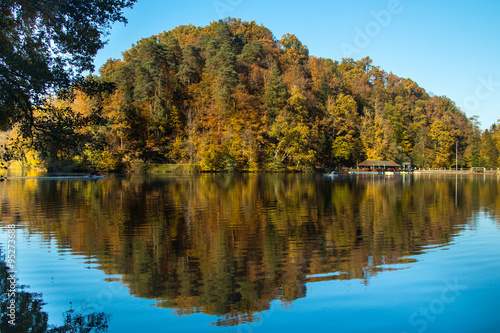  Boat floating on Trakoscan lake in Zagorje, Croatia, season, autumn, Reflection of trees on water 