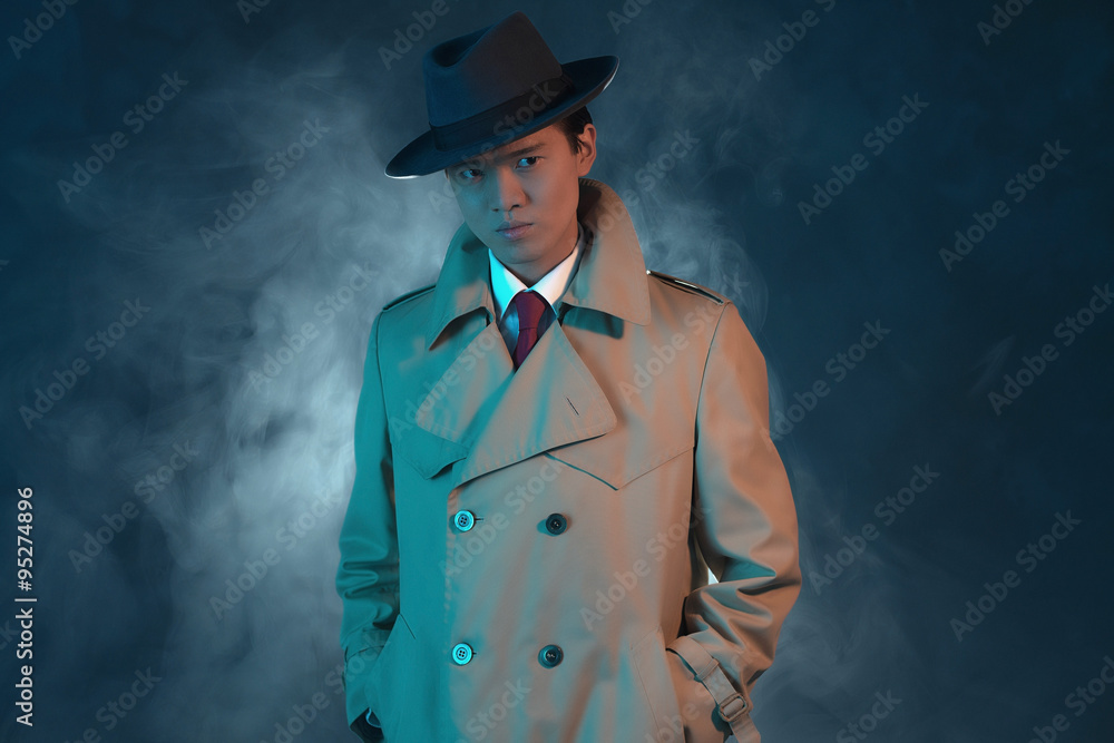 Mysterious retro 1940 asian gangster fashion man in raincoat. Stock-Foto |  Adobe Stock