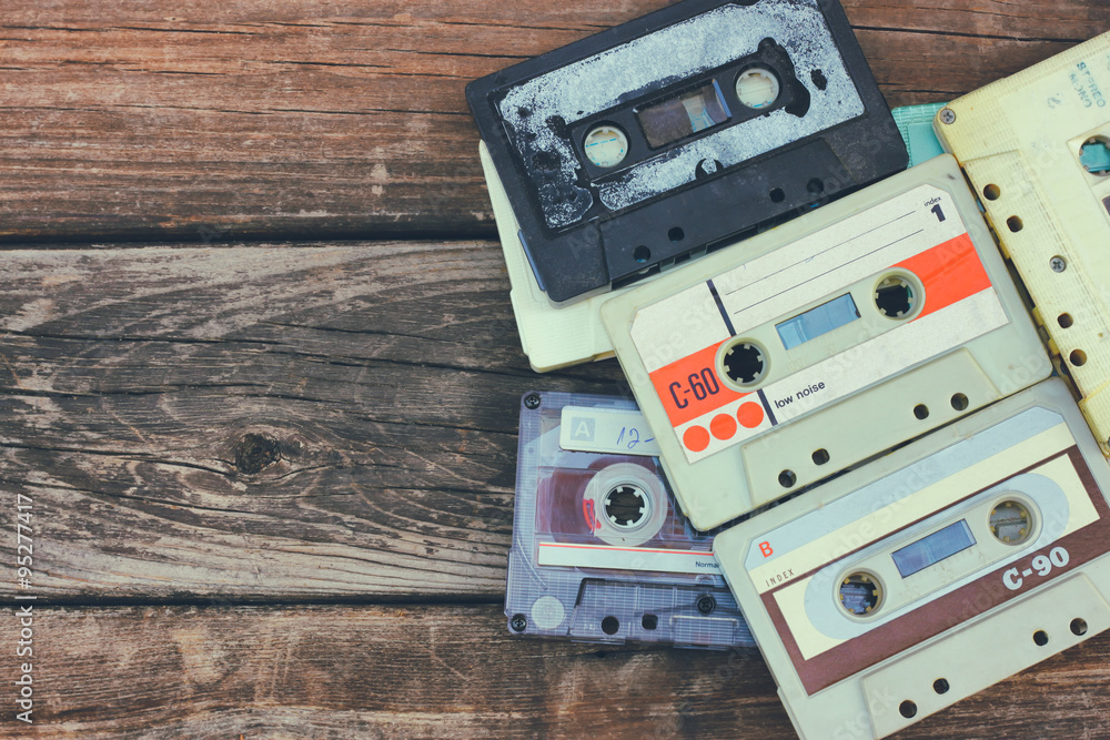 close up photo of cassette tape over wooden table . top view. retro filtered
close up photo of cassette tape over wooden table . top view. retro filtered