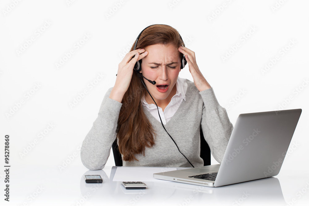 desperate 20s working woman under shock with headset and computer desperate 20s working woman under shock with headset and computer