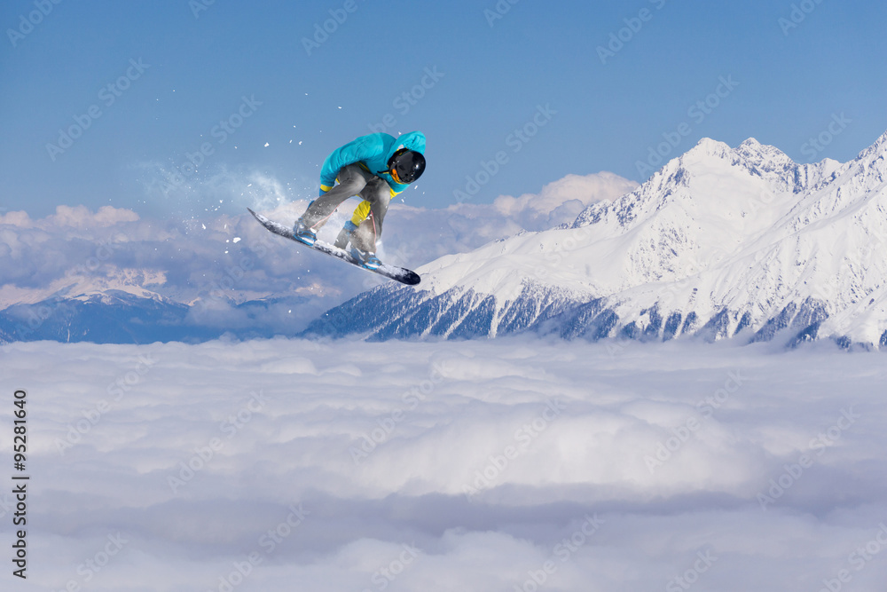 Flying snowboarder on mountains