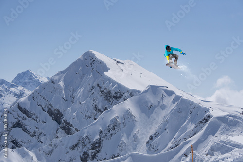 Flying snowboarder on mountains, extreme sport