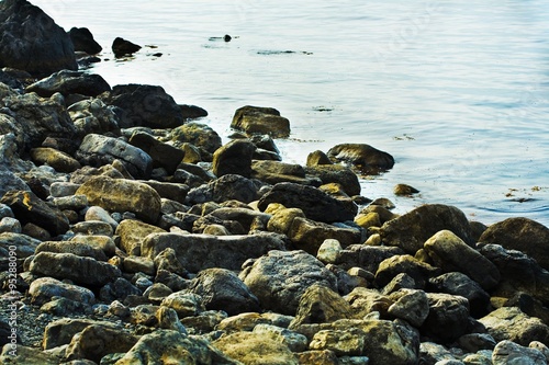 The European summer beach scene. Stones in water