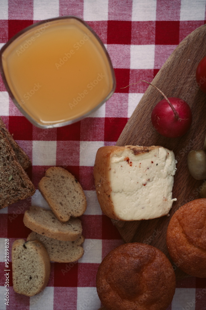 Breakfast with bread, radish, olives, cheese and juice. Breakfast with bread, radish, olives, cheese and juice.