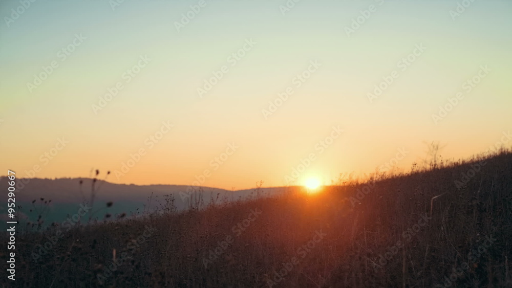 Happy kid playing with paper airplane on a hill slope. Sunrise in the background Happy kid playing with paper airplane on a hill slope. Sunrise in the background