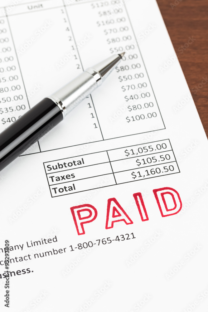 Obraz premium Invoice and pen with paid stamp; invoice is mock-up