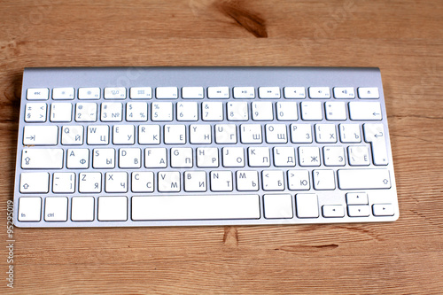Modern aluminum computer keyboard on the table