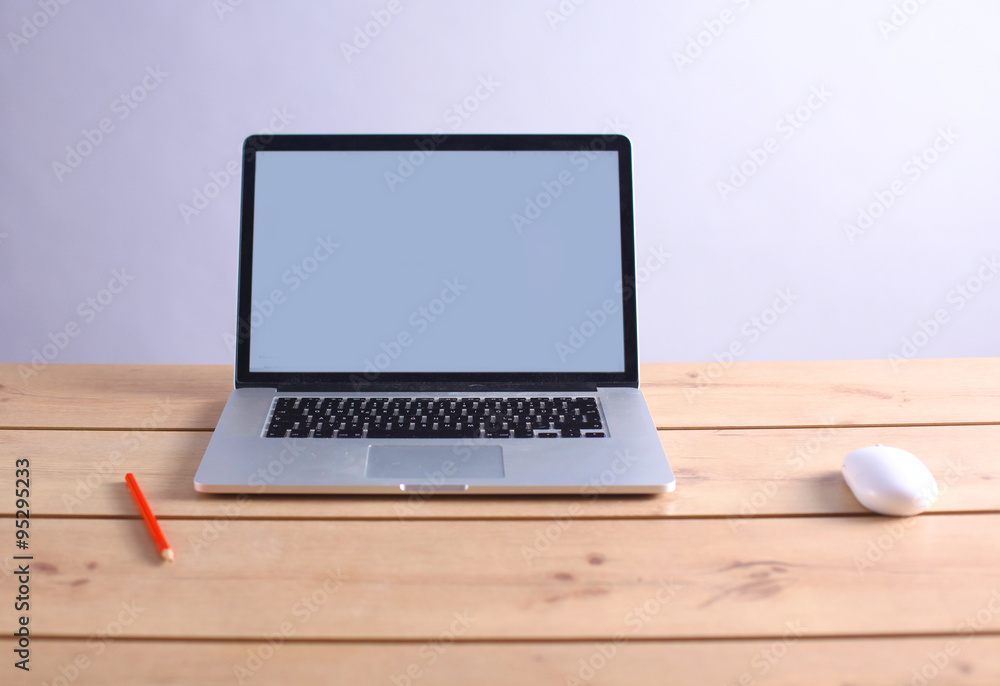 Laptop stands on a wooden table Laptop stands on a wooden table