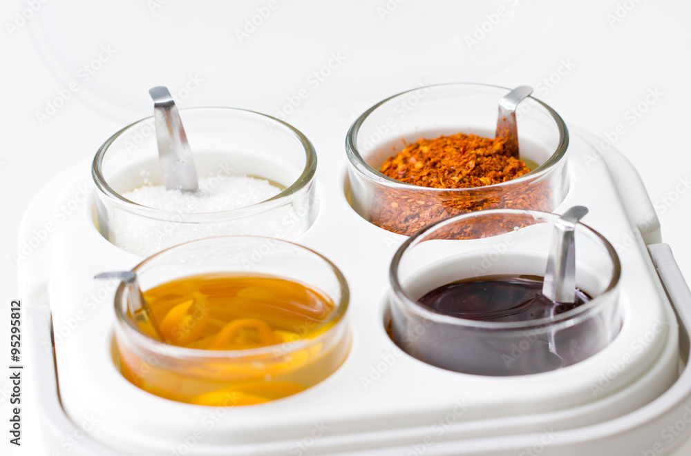Thai seasoning container include cayenne pepper, sugar, fish sauce and chilies in vinegar. Thai seasoning container include cayenne pepper, sugar, fish sauce and chilies in vinegar.