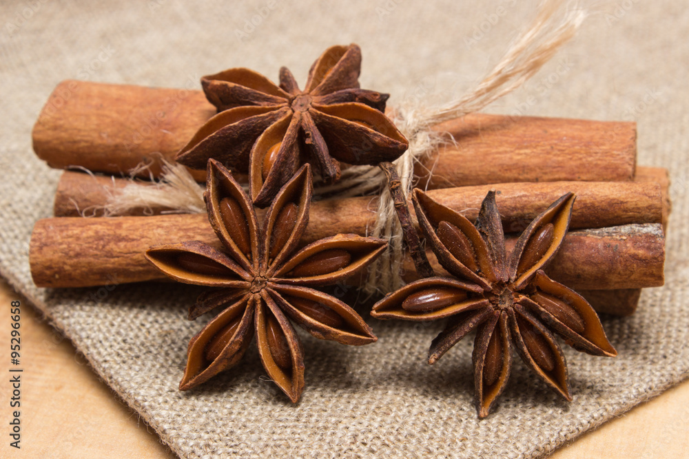 Star anise and cinnamon sticks on wooden table, seasoning for cooking Star anise and cinnamon sticks on wooden table, seasoning for cooking