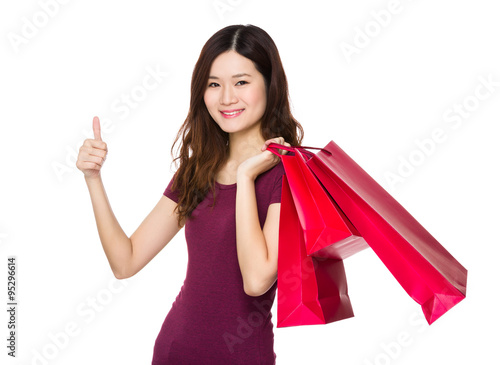 Asian Young Woman carry with shopping bag and thumb up