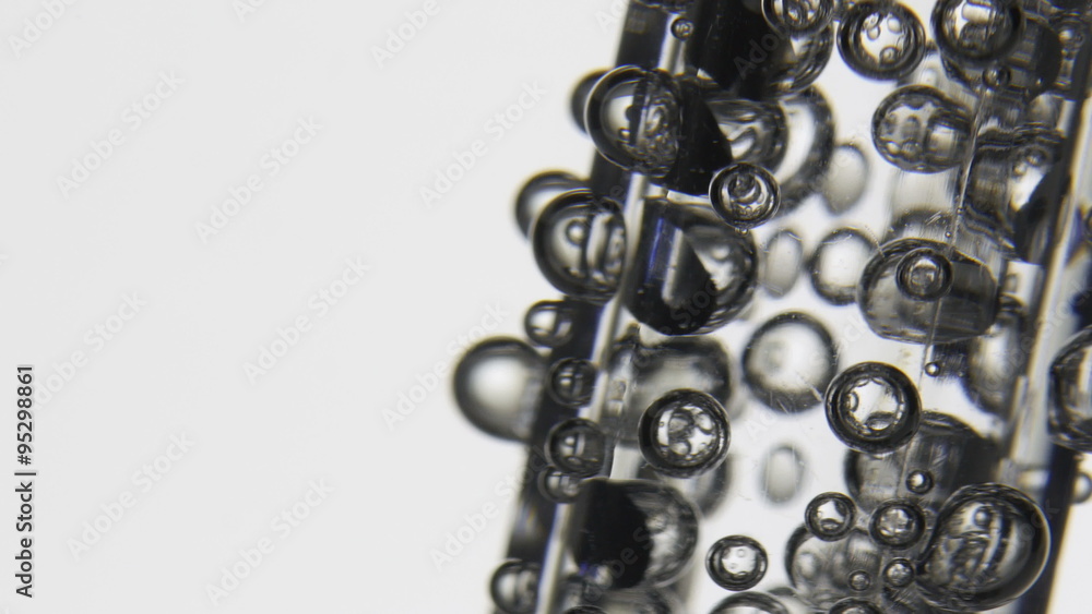 Sparkling bubbles rising in a abstract glass of clean water. Macro close-up shot. Sparkling bubbles rising in a abstract glass of clean water. Macro close-up shot.