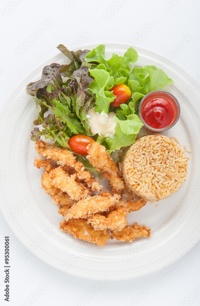 Fried chicken and garlic fried rice on the white plate Fried chicken and garlic fried rice on the white plate