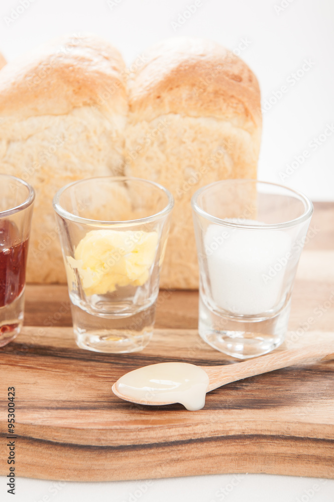 breakfast with toast fruit jam and butter on wood table breakfast with toast fruit jam and butter on wood table