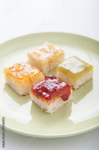 Mix fruit, blueberry, orange fruit jam spread on bread toast ove