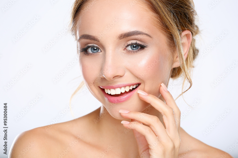 Young woman touching her face isolated on white background Young woman touching her face isolated on white background
